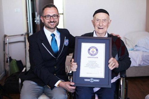 Guinness World Records’ Head of Records Marco Frigatti and 112-year-old Israel Kristal. Guinness World Records